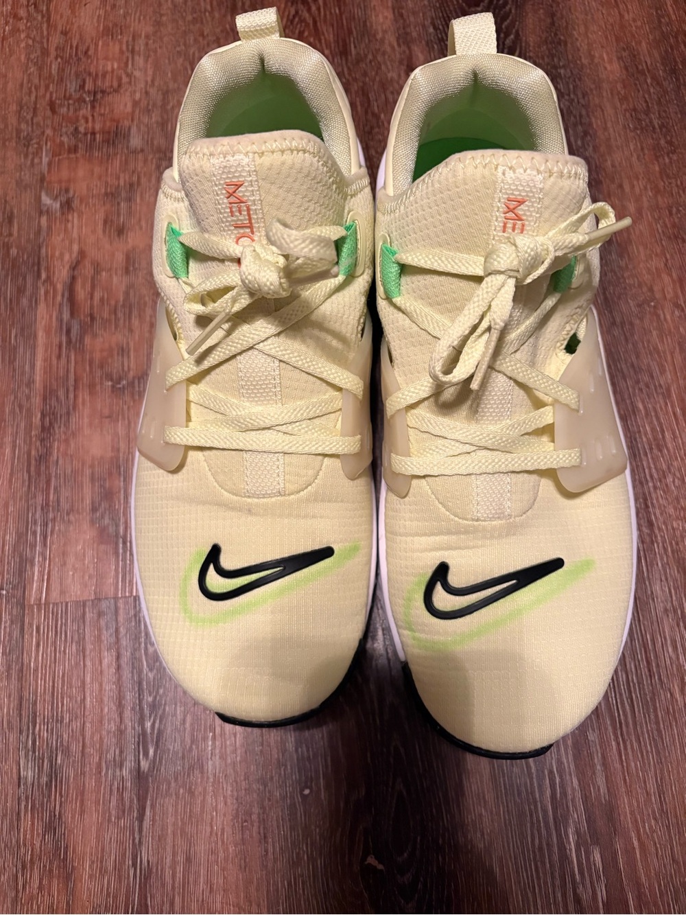 Nike women’s Yellow Sneakers with Black Swoosh and Green Accents
